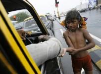A girl begs for alms in India.