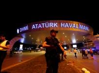 A riot police officer stands guard at the entrance of the Ataturk airport in Istanbul, Turkey, following a multiple suicide bombing, early June 29, 2016.