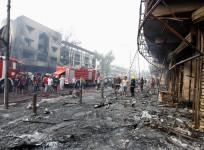 People inspect the site of a suicide car bomb in the Karrada shopping area, in Baghdad, Iraq July 3, 2016.