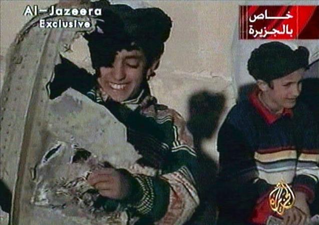 Picture taken from undated Al Jazeera television footage purportedly shows Hamza bin Osama bin Laden (L), one of the sons of Saudi-born dissident Osama bin Laden, displaying what the Taliban say is wreckage from a U.S. helicopter near Ghazni. hamza bin laden