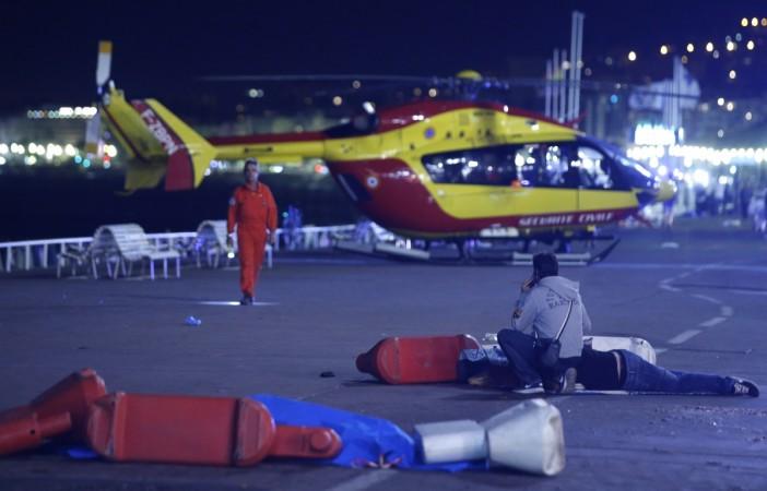 An injured individual is seen on the ground after at least 30 people were killed in Nice, France, when a truck ran into a crowd celebrating the Bastille Day national holiday July 14, 2016.