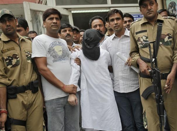 Sayeed Zabiuddin Ansari, with his face covered, leaves from a hospital in New Delhi June 29, 2012.