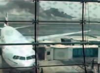 A still picture taken from an amateur video shows smoke rising (at rear) after an Emirates Airline flight crash-landed at Dubai International Airport, the UAE Aug. 3, 2016.