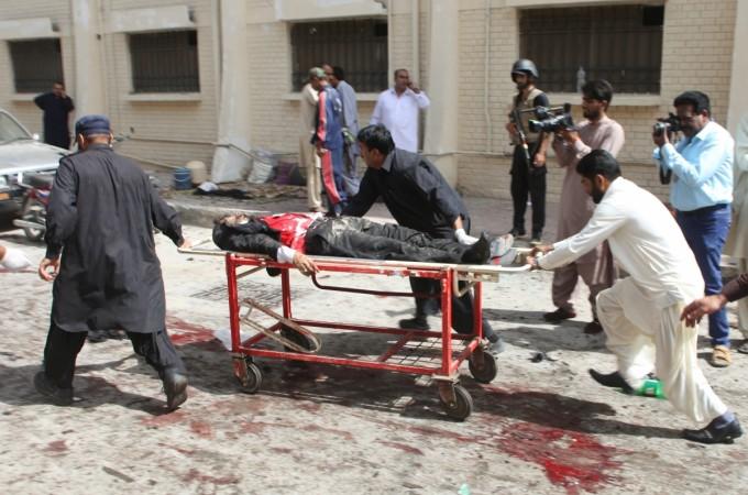 First responders and volunteers transport the injured and dead away from the scene of a bomb blast outside a hospital in Quetta, Pakistan, on Aug. 8, 2016.