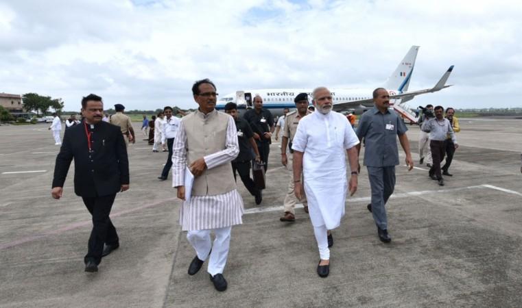 Prime Minister Narendra Modi is welcomed by Madhya Pradesh Chief Minister Shivraj Singh Chouhan in Indore, Madhya Pradesh, on Aug. 9, 2016.