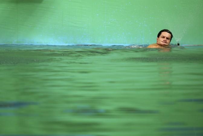 Patrick Hausding (GER) of Germany swims in the green coloured water of the diving pool at the Maria Lenk Aquatics Centre.