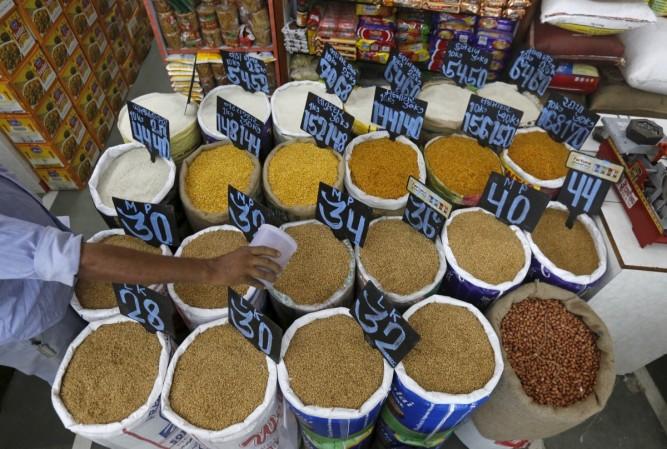 Wholesale inflation rose sharply in July on the back of spiralling prices of pulses, vegetables and sugar. In Picture: An employee collects wheat from a sack inside a grocery store at a residential area in Mumbai, India, March 14, 2016 (representational image) inflation wpi cpi retail modi govt repo rate rbi rajan speech independence day red fort achche din what narendra what is this elections record 70th balochistan