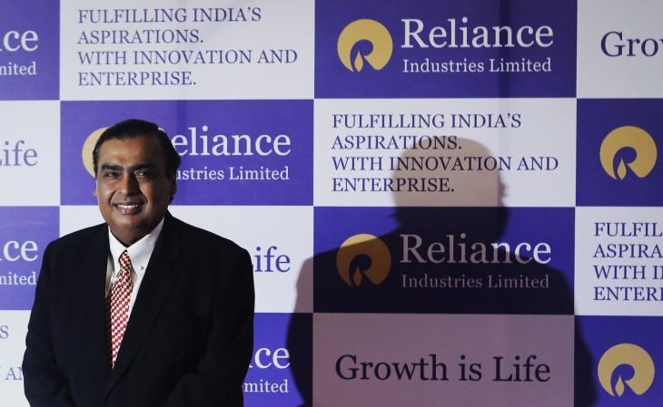 Mukesh Ambani, chairman of Reliance Industries Limited, poses for photographers before addressing the annual shareholders meeting in Mumbai June 6, 2013 RIL asks its 40,000 employees asked to switch from Airtel, Vodafone to Jio
