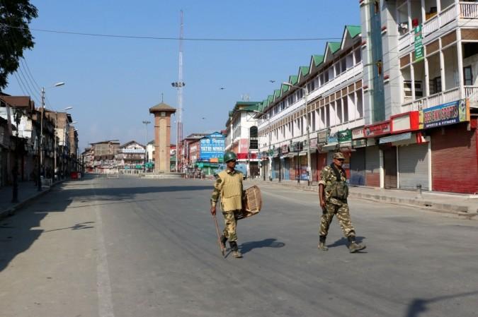 Soldiers deployed on Srinagar road as curfew continues for the 36th consecutive day in Kashmir on Aug. 13, 2016.