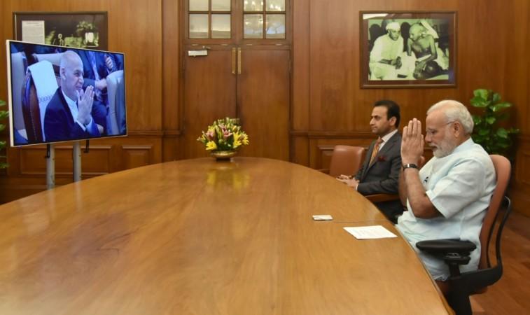 Prime Minister Narendra Modi greets Afghanistan President Mohammad Ashraf Ghani during the joint inauguration of the renovated Stor Palace in Kabul through video-conferencing, in New Delhi on Aug. 22, 2016.
