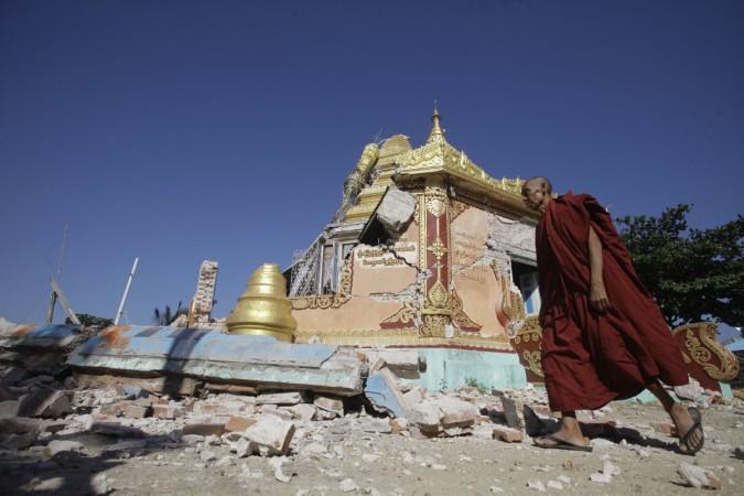A Buddhist monk walks in front of damaged pagoda in Thabeik Kyin township Nov. 12, 2012. Aftershocks rattled central Myanmar after an earthquake that killed at least 11 people, with that toll likely to rise on Monday as several workers were missing after