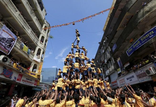 Devotees try to form a human pyramid to break a clay pot containing curd during celebrations to mark the Hindu festival of Janmashtami in Mumbai, India, Sept. 6, 2015.