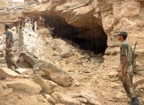 Pakistani soldiers stand at the cave hideout of slain Baloch rebel chief Akbar Bugti in Kohlu, about 220 km from Quetta, on Aug. 30, 2006. Violent protests have erupted across the Balochistan province since nationalist leader Nawab Akbar Khan Bugti was ki