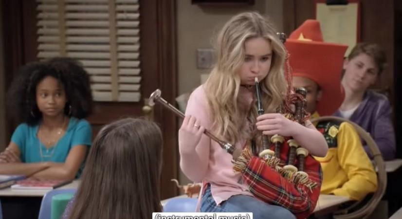 Maya blows bagpipe