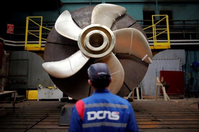 An employee looks at the propeller of a Scorpene submarine at the industrial site of the naval defence company and shipbuilder DCNS in La Montagne near Nantes, France, April 26, 2016.