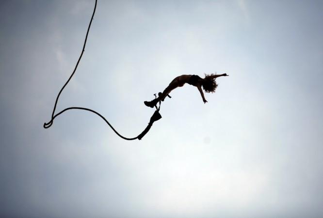 An adrenaline junkie enjoys a bungee jump. Adventure sports