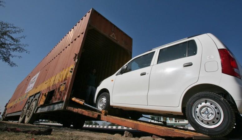 Maruti Suzuki exports touch 15 lakh marks. Pictured: A worker unloads an A-Star car from a container at a Maruti Suzuki stockyard .