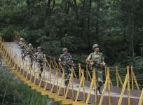 File photo of Indian Border Security Force (BSF) soldiers patrol over a footbridge near the Line of Control (LoC), a ceasefire line dividing Kashmir between India and Pakistan, at Sabjiyan sector of Poonch district.