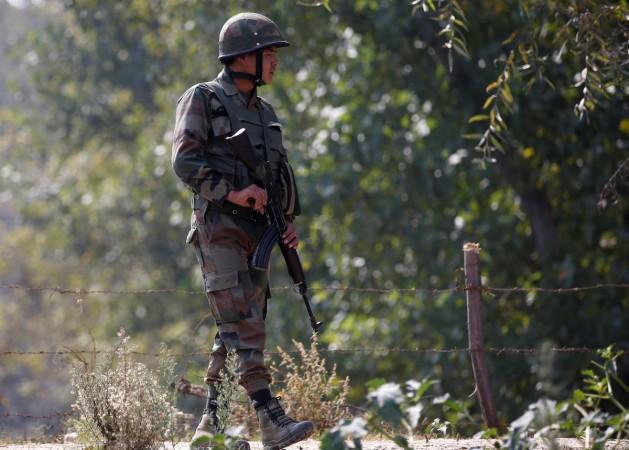 An Indian army soldier patrols along a highway on the outskirts of Srinagar