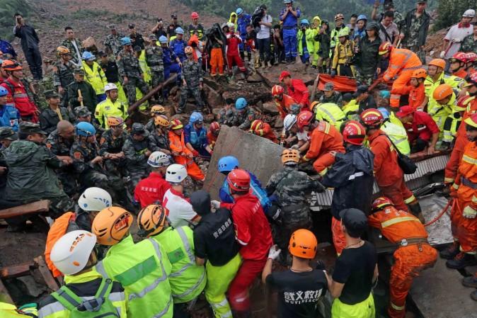 Rescue workers lift a piece of collapsed building at the site of a landslide caused by heavy rains brought by Typhoon Megi, in Sucun Village, Lishui, Zhejiang province, China, September 29, 2016 china landslide