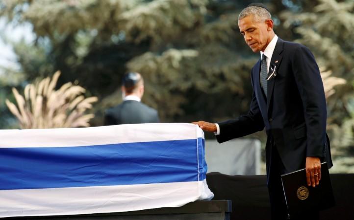 U.S President Barack Obama walks past the flag-draped coffin of former Israeli President Shimon Peres, after eulogising him at his funeral ceremony