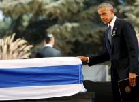 U.S President Barack Obama walks past the flag-draped coffin of former Israeli President Shimon Peres, after eulogising him at his funeral ceremony
