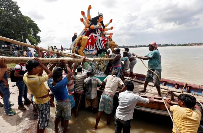 An idol of Hindu goddess Durga is being loaded onto a boat to transport it through the waters of river Ganga to a pandal, or a temporary platform, ahead of the Durga Puja festival in Kolkata, India, September 29, 2016. Navratri and Durga Puja
