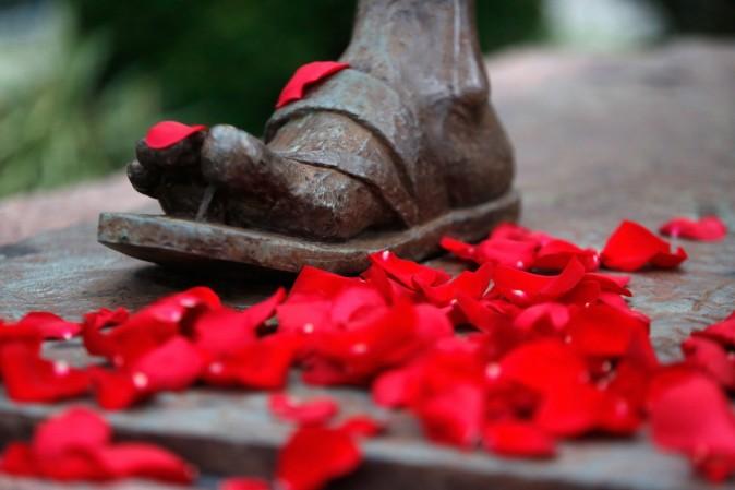 Flower petals lay scattered at the feet of the Mahatma Gandhi Statue in Washington. Mahatma Gandhi