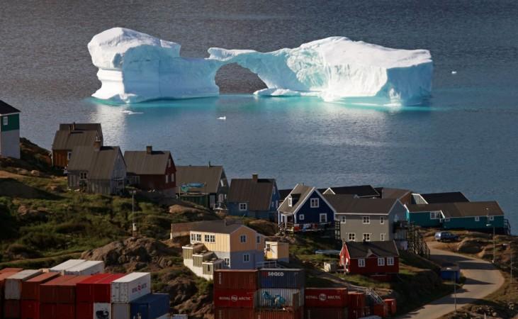 An iceberg floats near a harbour in the town of Kulusuk, east Greenland. Global Warming