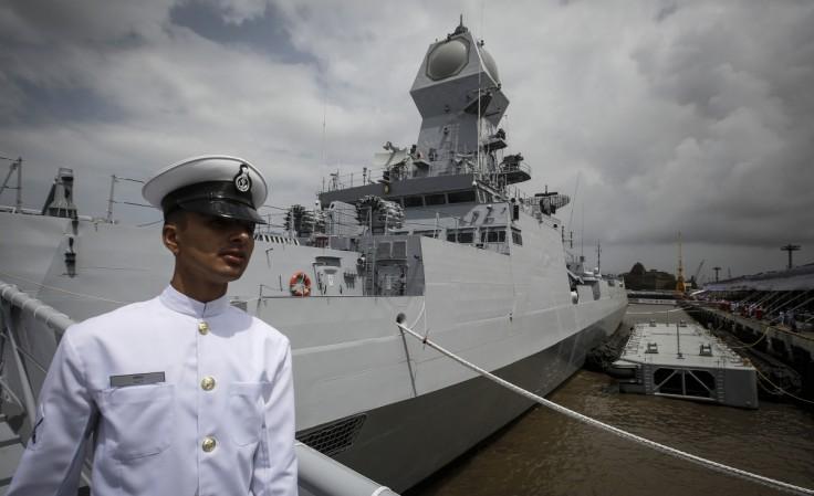 An Indian navy serviceman walks down the gangplank of the newly commissioned warship, INS Kolkata, during its commissioning ceremony at a naval base in Mumbai 16 August 2014. Indian Navy