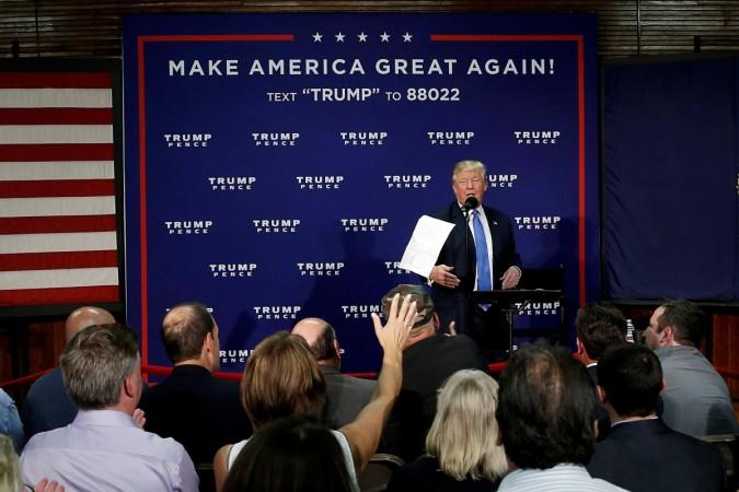 Donald Trump to address Hindu Americans in New Jersey. In Picture: Republican presidential nominee Donald Trump tosses a paper after reading poll results to the audience during a campaign town hall in Sandown, New Hampshire, US, 6 October 2016. Donald Trump