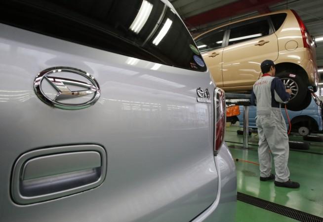 Toyota Daihatsu could soon be in India. Pictured: An engineer checks a wheel of a Daihatsu Motor Co.'s Move vehicle next to its Mira e:S at the company's dealership in Tokyo Toyota Daihatsu could soon be in India