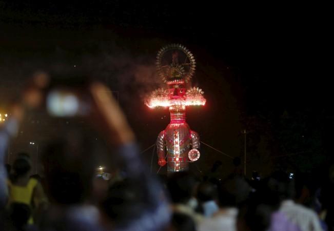 People watch as an effigy of demon king Ravana burns during the Hindu festival of Dussehra in in Mumbai, India, October 22, 2015. Effigies of the 10-headed Demon King Dussehra
