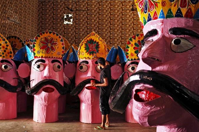 An artisan applies final touches to an effigy of the demon king Ravana in preparation for the upcoming Hindu festival of Dussehra in Jammu. Dussehra