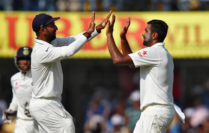 R Ashwin celebrates with Cheteshwar Pujara after picking up the wicket of Ross Taylor, October 11, 2016 Cheteshwar Pujara R Ashwin India
