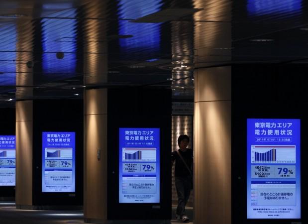 A man walks past electronic monitors