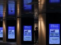 A man walks past electronic monitors