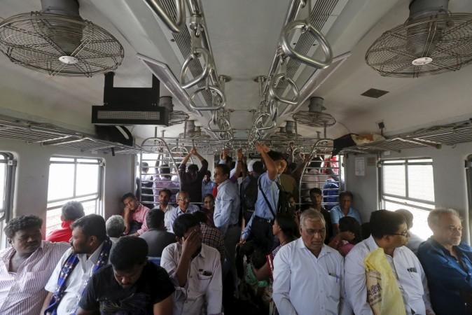Commuters travel by suburban train as they head toward their destination in Mumbai, India, February 17, 2016. central railway income earnings passengers suburban 2017 trains network stations press release april september