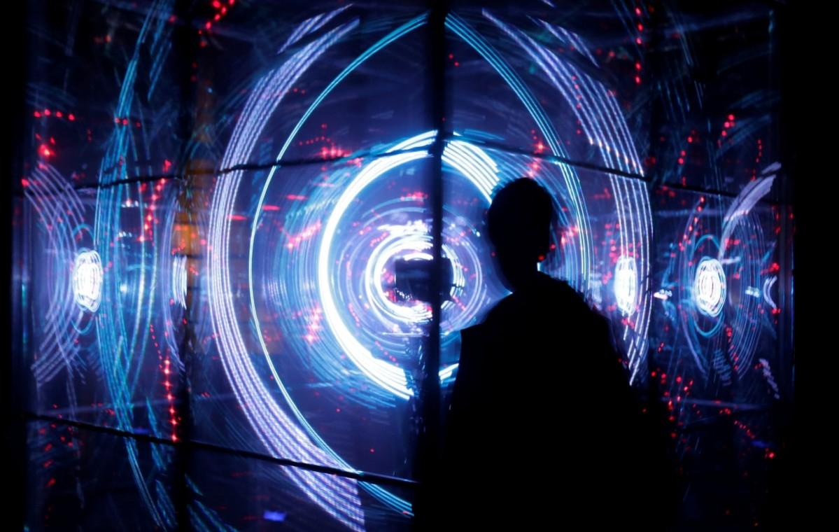 A man stands in front of the installation signal lights festival