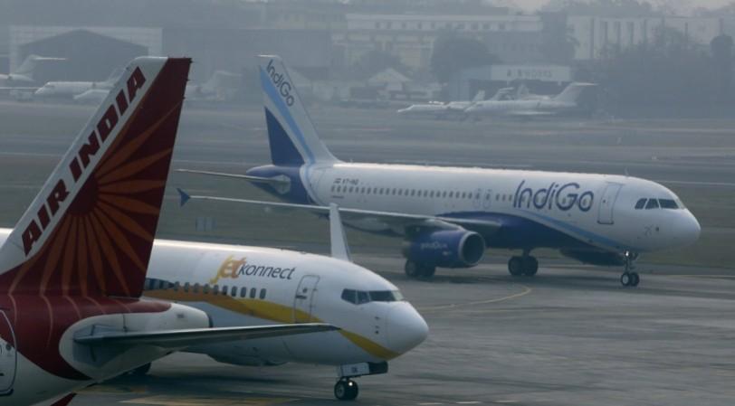 IndiGo Airlines and JetKonnect aircraft taxi past an Air India aircraft at Mumbai's Chhatrapathi Shivaji International Airport February 3, 2013. airplanes