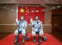 Chinese astronauts Jing Haipeng (L) and Chen Dong