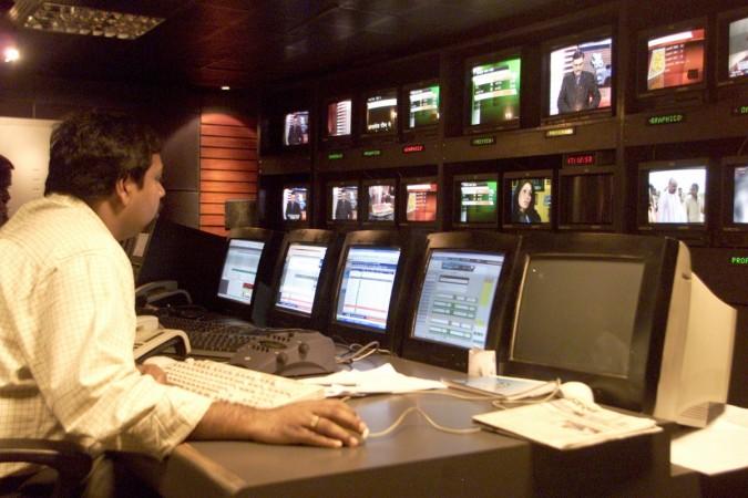 In Picture: An Indian news producer sits inside a news studio in New Delhi News India
