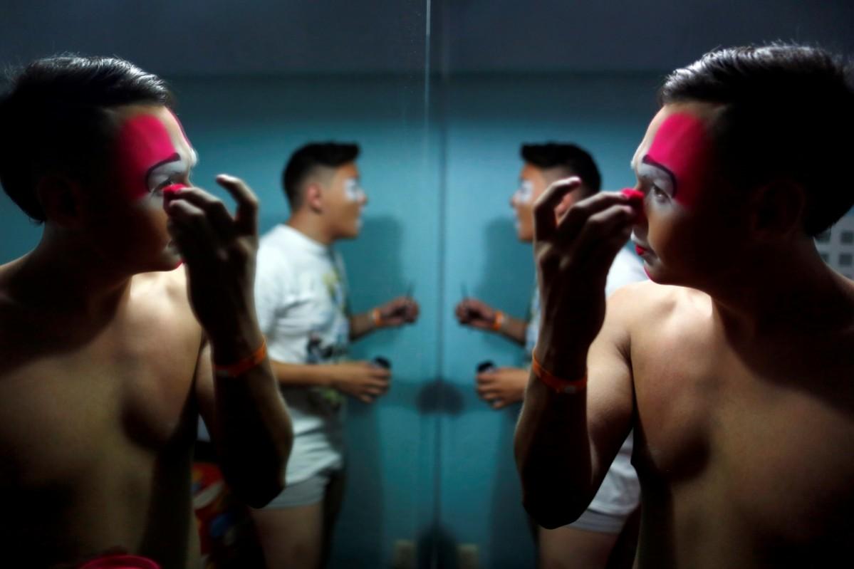 Eduardo Baquera, known as Cocoy Clown, puts on makeup during the XXI Convention of Clowns, at the Jimenez Rueda Theatre, in Mexico City, Mexico, October 19, 2016. Convention of Clowns