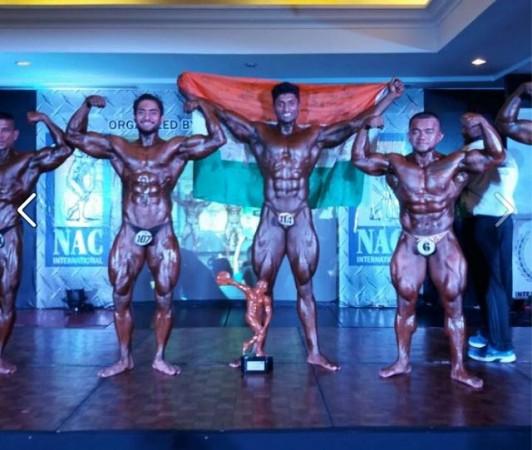 Mr. Asia 2016 winner G. Balakrishna in centre holding an Indian flag Mr. Asia 2016