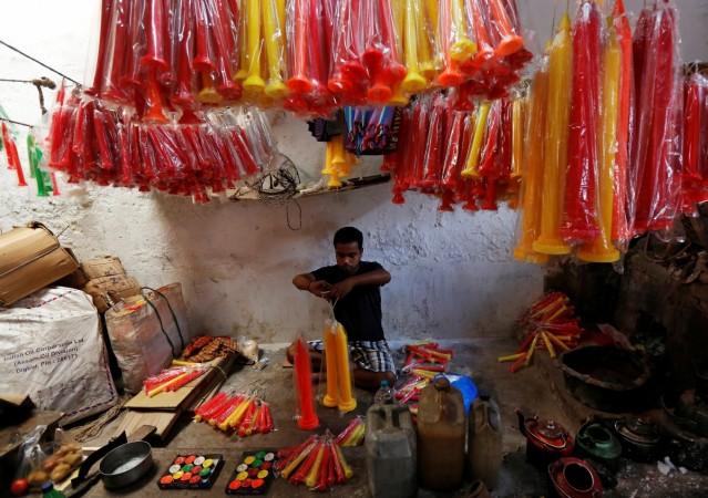 A worker packs candles, which are used to decorate temples and homes during Diwali, the Hindu festival of lights, at a candle-making factory in Kolkata. Diwali 2016