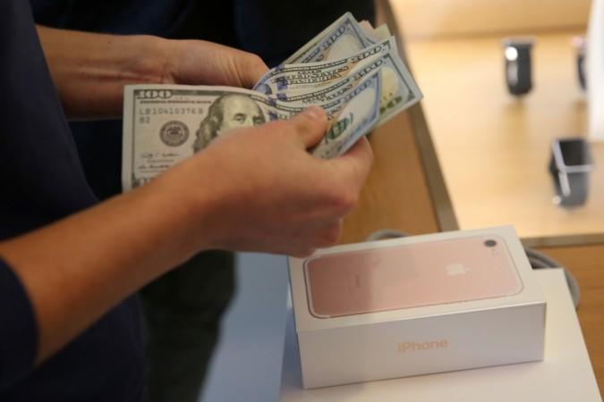 A customer buys the new iPhone 7 smartphone inside an Apple Inc. store in Los Angeles, California, U.S., September 16, 2016. Apple sales