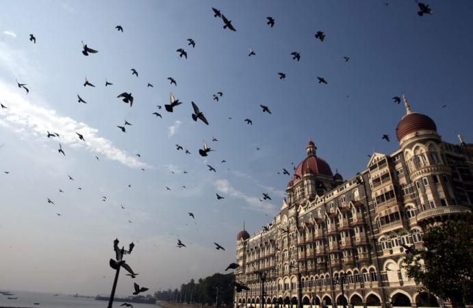 Pigeons fly around Taj Mahal hotel in Mumbai December 22, 2008. Mumbai