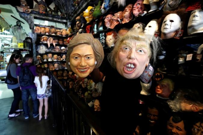 An employee holds up masks depicting Democratic presidential nominee Hillary Clinton and Republican presidential nominee Donald Trump at Hollywood Toys & Costumes in Los Angeles, California U.S halloween