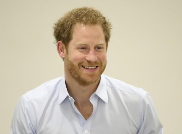 Prince Harry chats with staff during his visit to the Burrell Street Sexual Health Clinic in London, Britain on July 14, 2016. Prince Harry
