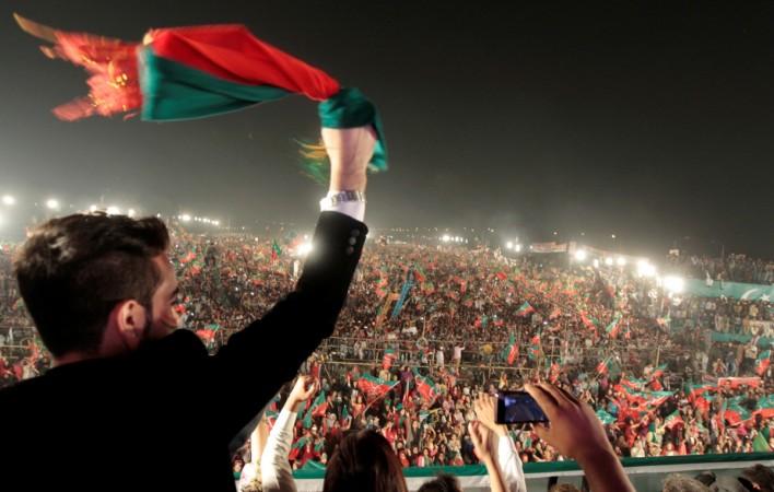 Supporters of opposition politician Imran Khan cheer at a celebration rally in Islamabad Pakistan name Indian diplomats